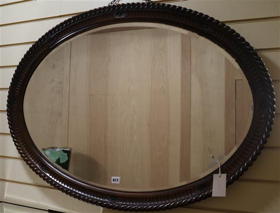 An oval mirror, W.104cm